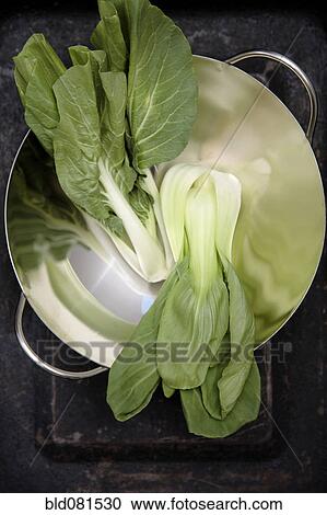 Stock Image - Shanghai and baby bok choy in wok. Fotosearch