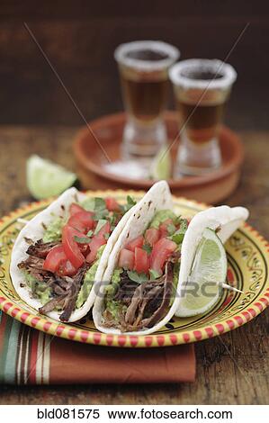 Shredded beef tacos and tequila shots View Large Photo Image Stock Photography - Shredded beef tacos and tequila shots. Fotosearch