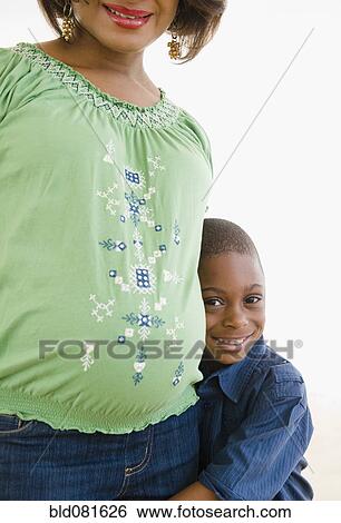 Smiling Black boy hugging mother View Large Photo Image Stock Photograph - Smiling Black boy hugging mother. Fotosearch