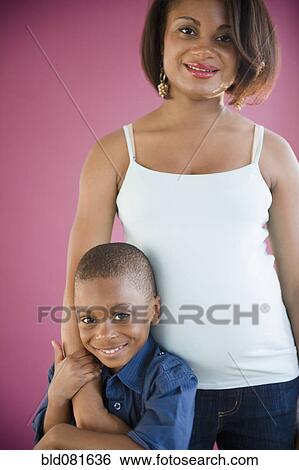 Stock Photograph - Smiling Black mother and son hugging. Fotosearch