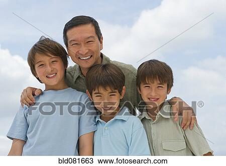 Stock Image - Smiling father and sons. Fotosearch