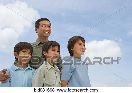 Stock Photo - Smiling father and sons. Fotosearch