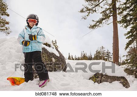 Smiling girl with sled in snow View Large Photo Image Stock Photo - Smiling girl with sled in snow. Fotosearch