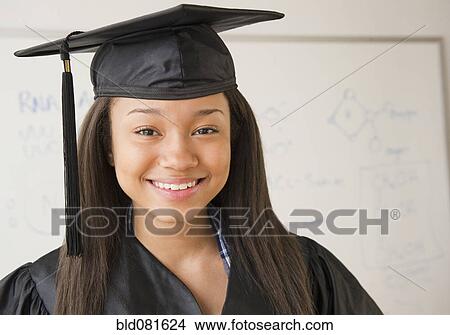 Smiling mixed race teenage girl wearing cap and gown View Large Photo Image Picture - Smiling mixed race teenage girl wearing cap and gown. Fotosearch