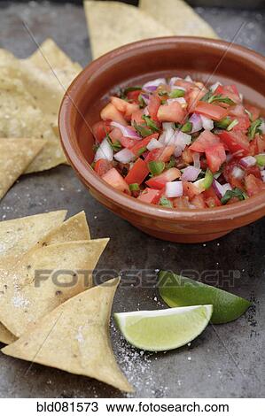 Stock Image - Tortilla chips and salsa fresca. Fotosearch