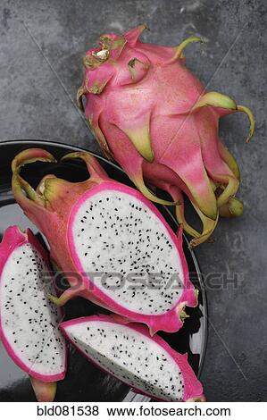 Stock Photo - Whole and sliced dragon fruit. Fotosearch