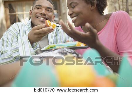 African American couple eating oranges outdoors View Large Photo Image Stock Image - African American couple eating oranges outdoors. Fotosearch