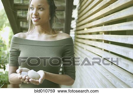 African American woman holding stones outdoors View Large Photo Image Stock Photo - African American woman holding stones outdoors. Fotosearch