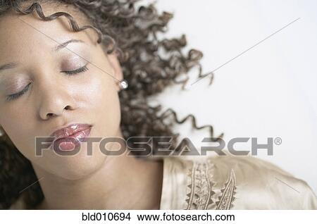 Picture - African American woman with eyes closed. Fotosearch