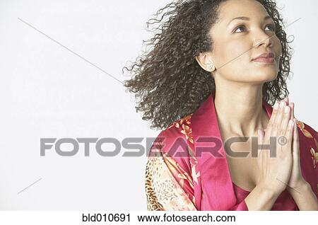 African American woman with hands together and hair flowing back View Large Photo Image Stock Image - African American woman with hands together and hair flowing back. Fotosearch