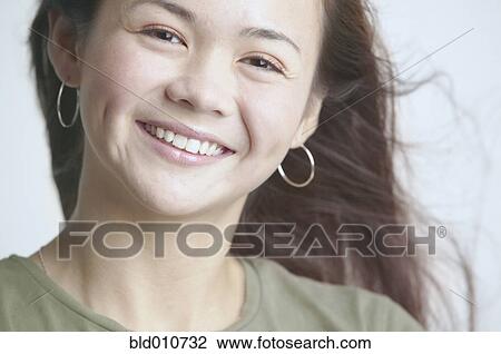 Asian woman smiling with hair blowing View Large Photo Image Stock Image - Asian woman smiling with hair blowing. Fotosearch