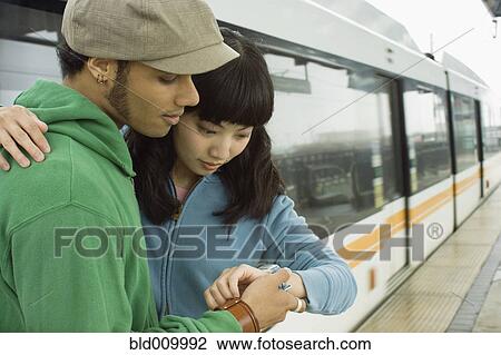 Stock Photo - Couple at train station. Fotosearch - Search Stock Photography, Print Pictures, Images, and Photo Clip Art