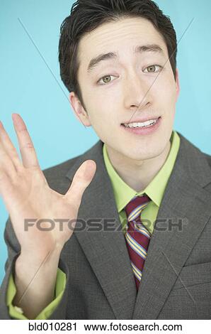 Stock Image - Businessman gesturing with his hand. Fotosearch