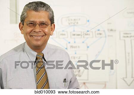 Stock Image - Businessman next to chart. Fotosearch