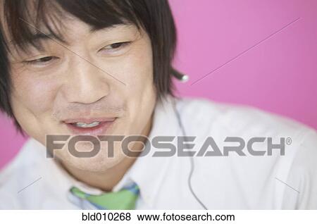 Stock Photo - Businessman smiling while chatting. Fotosearch