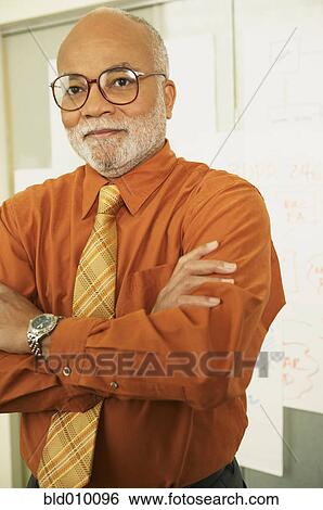 Businessman standing in front of charts View Large Photo Image Stock Photograph - Businessman standing in front of charts. Fotosearch