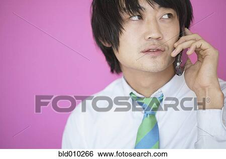 Businessman talking on a mobile phone View Large Photo Image Stock Photograph - Businessman talking on a mobile phone. Fotosearch