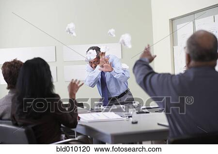 Businesspeople throwing paper balls View Large Photo Image Stock Image - Businesspeople throwing paper balls. Fotosearch