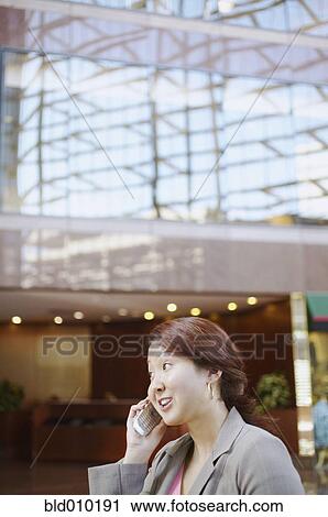 Businesswoman talking on a mobile phone View Large Photo Image Stock Image - Businesswoman talking on a mobile phone. Fotosearch