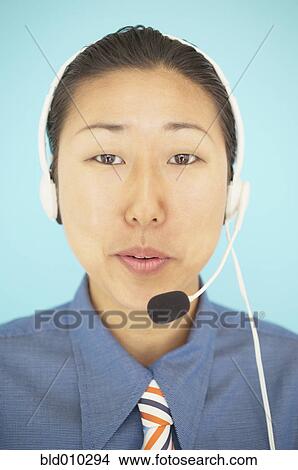 Businesswoman wearing a headset View Large Photo Image Picture - Businesswoman wearing a headset. Fotosearch