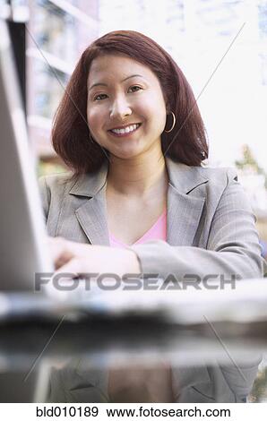 Stock Photo - Businesswoman working on a laptop. Fotosearch