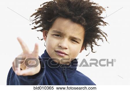 Stock Photography - Close up of a boy making the peace sign. Fotosearch