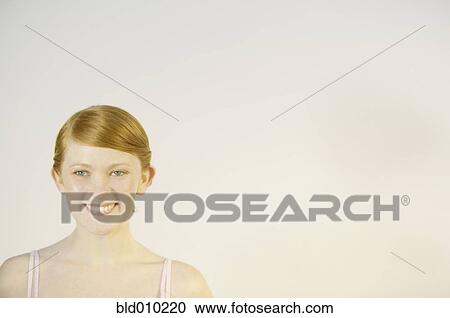 Stock Image - Close up of a young woman smiling. Fotosearch