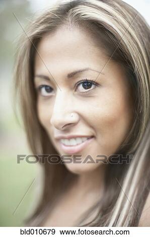 Close up of a young woman smiling View Large Photo Image Stock Photo - Close up of a young woman smiling. Fotosearch