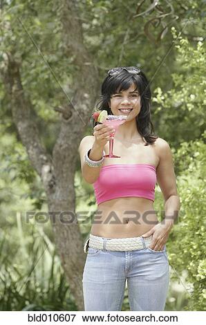 Stock Photo - Close up of woman holding flowers. Fotosearch