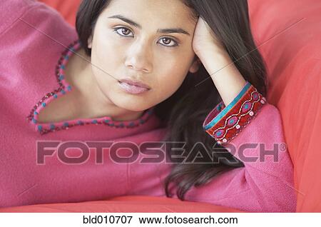 Close up of woman on sofa View Large Photo Image Stock Photo - Close up of woman on sofa. Fotosearch