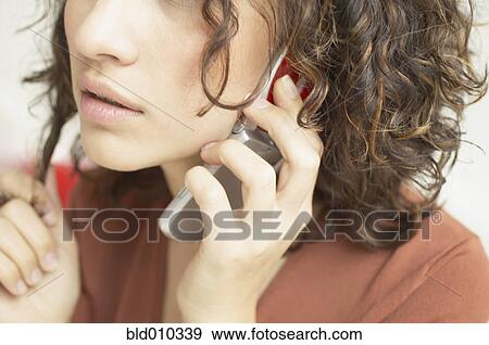 Close up of woman talking on mobile phone View Large Photo Image Stock Photo - Close up of woman talking on mobile phone. Fotosearch