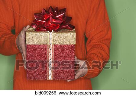 Stock Photograph - Close-up view of man holding a gift. Fotosearch