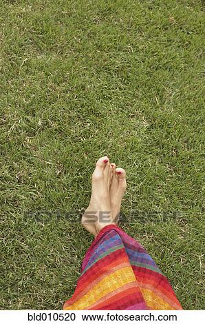 Feet of young woman on grass View Large Photo Image Stock Image - Feet of young woman on grass. Fotosearch