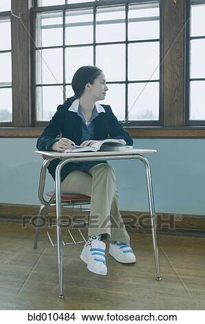 Picture - Female high school student at desk. Fotosearch