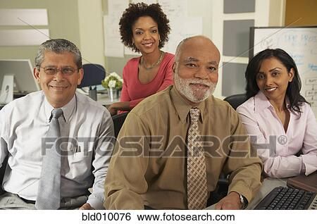 Stock Photograph - Four businesspeople sitting together. Fotosearch