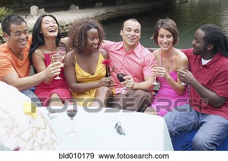 Friends holding glasses of wine View Large Photo Image Stock Photo - Friends holding glasses of wine. Fotosearch
