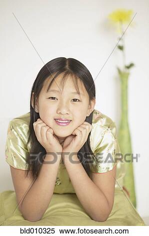 Girl resting her chin on her hands View Large Photo Image Stock Photography - Girl resting her chin on her hands. Fotosearch
