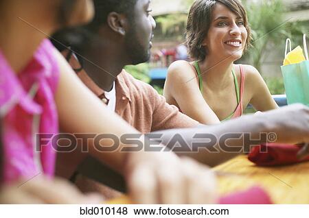 Group of young adults sitting together View Large Photo Image Stock Photo - Group of young adults sitting together. Fotosearch