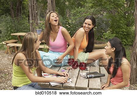 Group of young women talking outdoors View Large Photo Image Stock Photo - Group of young women talking outdoors. Fotosearch