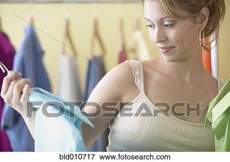 Hispanic women looking at men's clothes in boutique View Large Photo Image Stock Photo - Hispanic women looking at men's clothes in boutique. Fotosearch