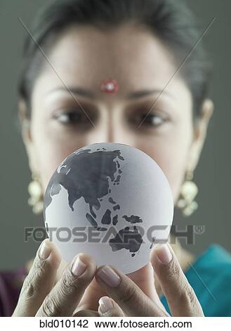 Indian woman wearing bindi and holding small glass globe View Large Photo Image Stock Image - Indian woman wearing bindi and holding small glass globe. Fotosearch