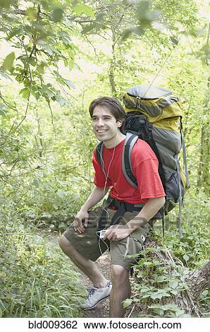 Stock Image - Male hiker listening to music. Fotosearch
