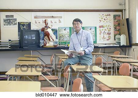Stock Photo - Male teacher in classroom. Fotosearch