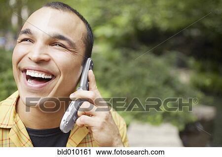 Man enjoying a mobile phone conversation View Large Photo Image Stock Image - Man enjoying a mobile phone conversation. Fotosearch