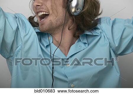 Stock Image - Man singing and wearing headphones. Fotosearch