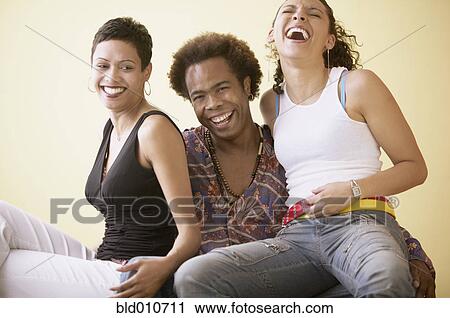 Man with two women laughing View Large Photo Image Stock Image - Man with two women laughing. Fotosearch