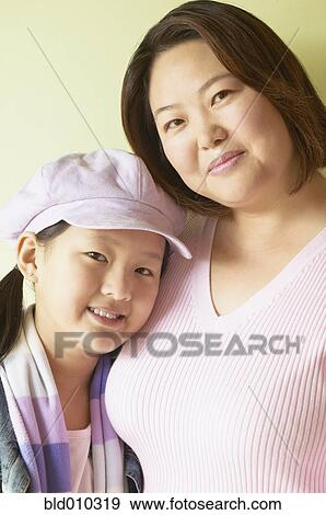 Stock Photo - Mother and daughter standing together. Fotosearch