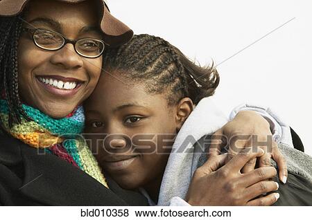 Stock Photo - Mother hugging daughter. Fotosearch