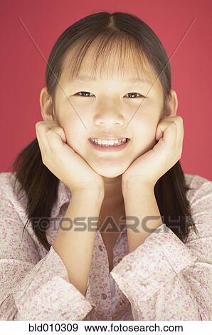 Portrait of a young girl smiling View Large Photo Image Stock Photo - Portrait of a young girl smiling. Fotosearch