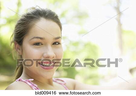 Portrait of a young woman smiling View Large Photo Image Stock Photograph - Portrait of a young woman smiling. Fotosearch